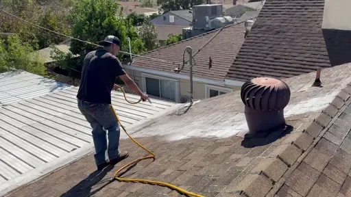 Relife Roofing technician applying roof rejuvenation treatment