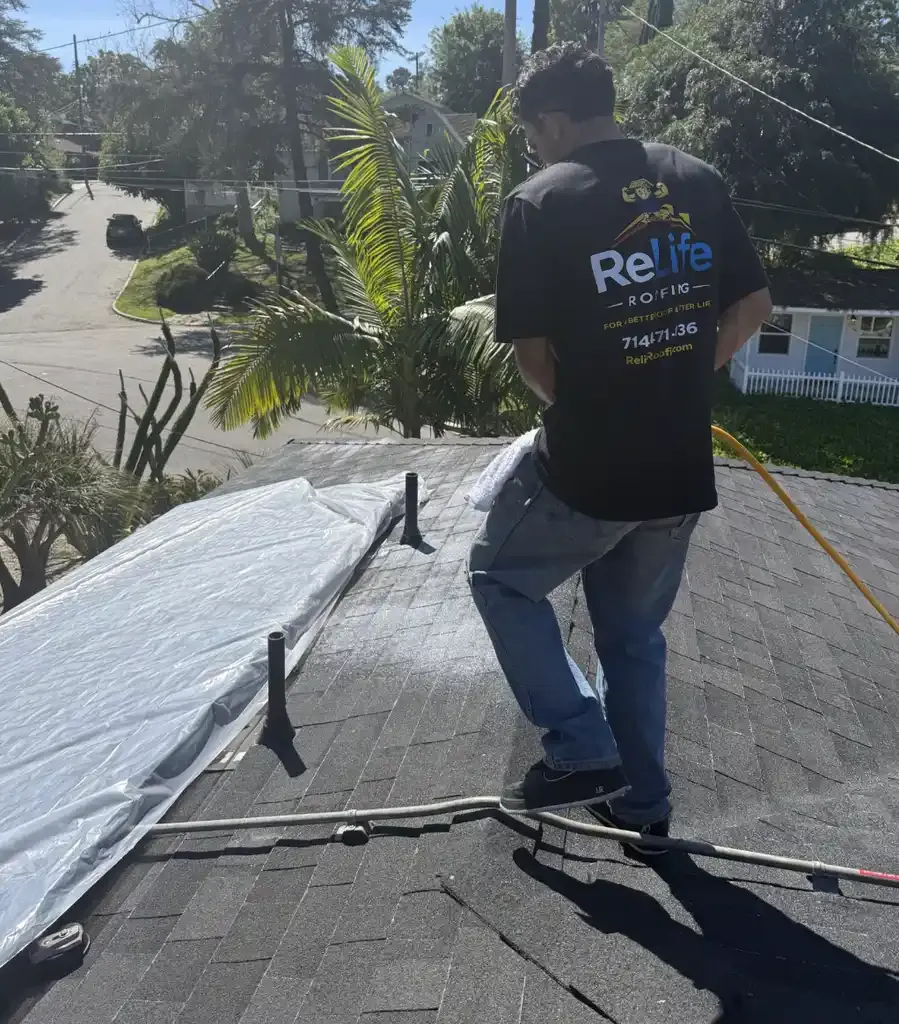 Relife Roofing crew member in branded shirt working on a Los Angeles area asphalt shingle roof